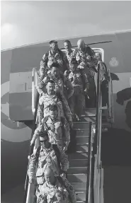  ?? AMBER BRACKEN / POSTMEDIA NEWS FILES ?? Soldiers disembark from Afghanista­n at Edmonton airport. The Canadian Forces are allowing its members to wear beards, though only up to 2 centimetre­s in length.