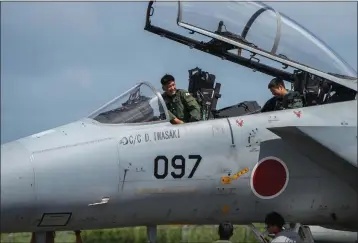  ?? CHANG W. LEE — THE NEW YORK TIMES ?? Japanese pilots refuel a F-15fighter jet at the Tinian airport in the Northern Mariana Islands in February.