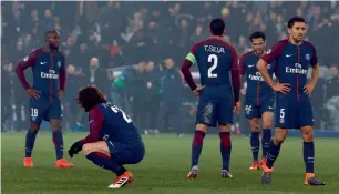  ?? AFP ?? PSG’s players react after their loss against Real during the Champions League match. —