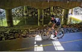  ?? JONATHAN PHILLIPS / SPECIAL TO THE AJC 2014 ?? A bicycle rider travels the path of the Big Creek Greenway in Alpharetta. The 8-mile route with several trailheads runs to Roswell.