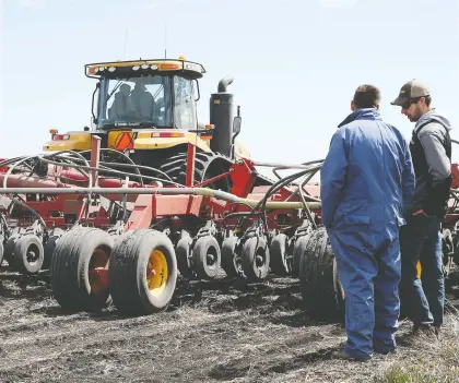  ?? SHANNON VANRAES/BLOOMBERG FILES ?? A tractor pulls an air seeder while planting canola on a farm near St. François Xavier, Man. If Canada treats its challenges with China as a sideshow without understand­ing the country more deeply, they will surely last a long time, says Toban Dyck.