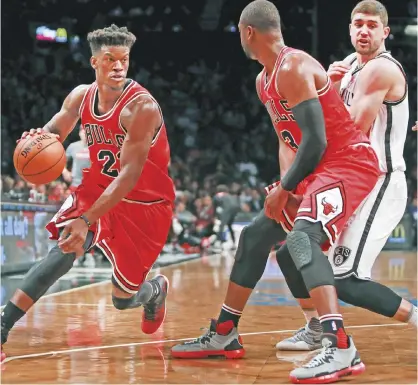  ??  ?? NEW YORK: Jimmy Butler #21 of the Chicago Bulls drives around a pick against the Brooklyn Nets during the second half at Barclays Center on Monday in New York City. — AFP