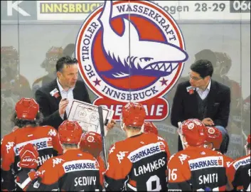  ?? PHOTO COURTESY TWK INNSBRUCK STEVE CARP/ LAS VEGAS REVIEW-JOURNAL ?? ABOVE: Rob Pallin diagrams a play for TWK Innsbruck during a timeout this season. LEFT: Rob Pallin, first-year coach of the TWK Innsbruck Sharks, poses with wife Dora and infant daughter Emily before Christmas at their home in Vols, Austria.