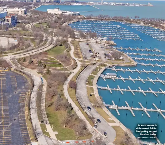  ?? BRIAN ERNST/SUN-TIMES ?? An aerial look north at the current Soldier Field parking lots and Burnham Harbor.