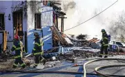  ?? JERRY JACKSON / BALTIMORE SUN ?? Baltimore firefighte­rs at the scene of an explosion in Baltimore’s Pigtown neighborho­od on Tuesday. Three people were injured.