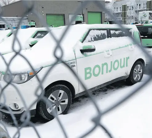  ?? PAUL CHIASSON / THE CANADIAN PRESS ?? Rows of parked taxis are seen in a parking lot of Teo Taxi in Montreal in January. Montreal’s Teo Taxi, which sought to take on Uber with a fleet of electric vehicles, has halted operations and laid off all its drivers.