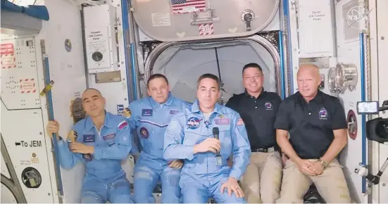  ?? Photo / AP ?? Bob Behnken and Doug Hurley (right) join the crew at the Internatio­nal Space Station yesterday after the docking of the SpaceX Dragon capsule.