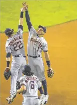  ?? Godofredo A. Vasquez / Houston Chronicle ?? Astros players Josh Reddick, Carlos Correa and Jake Marisnick celebrate a win over the Nationals in Game 3 in Washington.