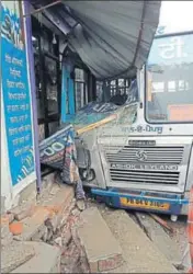  ??  ?? A PRTC bus after ramming into a shopfront at Singhawala village in Moga on Wednesday.