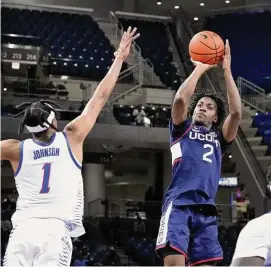  ?? Charles Rex Arbogast/Associated Press ?? UConn’s Tristen Newton (2) shoots over DePaul’s Javan Johnson during the first half on Tuesday in Chicago.