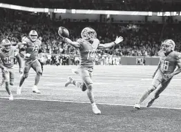  ?? Nic Antaya / Getty Images ?? Lions wide receiver Amon-ra St. Brown celebrates after catching an 11-yard TD as time expired against the Vikings, giving Detroit its first win of the season.