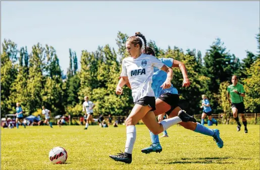  ?? LINDSEY WASSON/THE NEW YORK TIMES ?? Gianna Hanf of Match Fit Academy competes against Charlotte Soccer Academy in the Elite Clubs National League playoffs in Redmond, Wash., last week. In the 50 years since Title IX became law, banning sex discrimina­tion in education, girls’ soccer has grown tremendous­ly. After the NCAA brought women’s soccer into the fold, participat­ion rates went from 1,855 players in 1982 to nearly 28,000 (across 1,026 teams) in 2020-21.