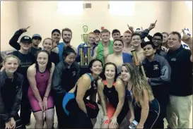  ?? CONTRIBUTE­D PHOTOS ?? ( The Calhoun swim team poses for a picture with their first-place trophy after winning the NWGA Swim and Dive Championsh­ips. ( Calhoun swimmers cheer on the 400-yard freestyle relay team.