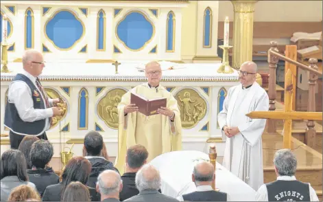  ?? STU NEATBY/THE GUARDIAN ?? Fr. Albin Arsenault, centre, and Fr. John Molina, right, preside over the funeral of Glen DesRoches, who, along with Moe Getson, died when their fishing vessel capsized off North Cape on Sept. 18. Close to 600 people attended the funeral at St. Simon and St. Jude church in Tignish on Thursday.