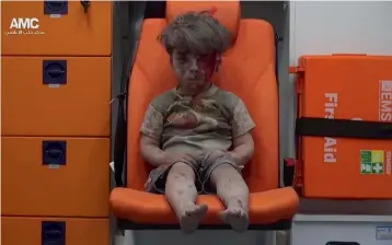 ?? — AP ?? In this August 17, 2016 file frame grab taken from video provided by the Syrian anti-government activist group Aleppo Media Centre (AMC), five-year-old Omran Daqneesh sits in an ambulance after being pulled out of a building hit by an airstrike in...