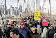  ?? Eduardo Munoz Alvarez / Associated Press ?? People march across the Brooklyn Bridge on Sunday to decry anti-Semitic attacks that have shaken the Jewish community in the New York area.