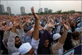  ?? AP/B.K. BANGASH ?? Pakistani religious students and other protesters raise their hands Wednesday in condemnati­on of the country’s Supreme Court landmark ruling acquitting Asia Bibi, a Roman Catholic mother of five who was sentenced to death for blasphemy in 2010.