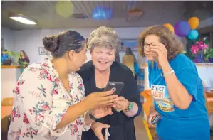  ?? EDDIE MOORE/JOURNAL ?? Susan Herrera, center, checks Democratic primary election returns with daughter-in-law Charlotte Madueno, left, and Cristina McCandless at an Española brew pub Tuesday night. She defeated 25-year incumbent Debbie Rodella in House District 41.