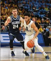  ?? STACY REVERE / GETTY IMAGES ?? Marquette’s Markus Howard, a 5-11 junior, drives around Villanova’s Joe Cremo in Milwaukee during a game on Saturday. He had 38 points in the win against the reigning national champion.