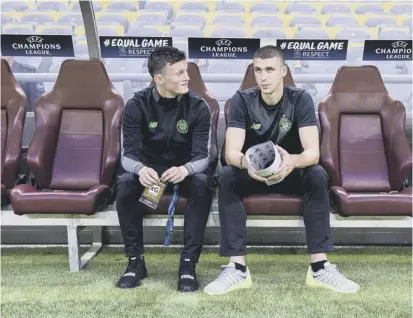  ??  ?? Liam Henderson, left, has a watching brief at Celtic’s Champions League play-off tie in Astana last month.