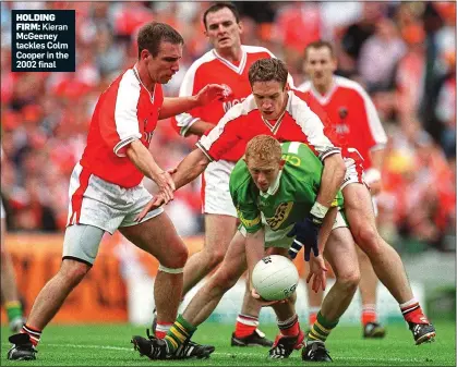  ??  ?? HOLDING
FIRM: Kieran McGeeney tackles Colm Cooper in the 2002 final