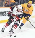  ??  ?? Coyotes left wing Taylor Hall skates with the puck against Predators defenseman Roman Josi in Monday night’s game in Nashville, Tenn.