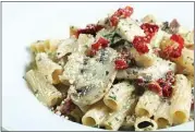  ?? COURTESY OF ROMANO’S MACARONI GRILL ?? Romano’s Macaroni Grill’s pasta Milano is rigatoni in roasted-garlic cream sauce topped with roasted chicken, sun-dried tomatoes and mushrooms.