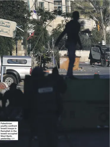  ?? AFP ?? Palestinia­n youths confront Israeli troops in Ramallah in the Israeli-occupied West Bank, yesterday