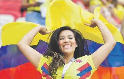  ?? Picture: AFP ?? A Colombian fan waves a flag as she cheers on her team during their 2-0 win over Poland on Sunday.