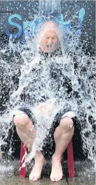  ?? PHOTOS: PETER MCINTOSH ?? Caption3
Splash . . . Kaikorai Primary School principal Simon Clarke gets a dunking of cold water, in the name of fundraisin­g, during the school’s street party on Saturday.