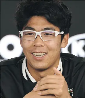  ?? WILLIAM WEST / GETTY IMAGES ?? South Korea’s Hyeon Chung smiles during a news conference after defeating Novak Djokovic at the Australian Open.