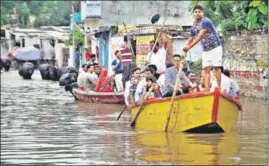  ??  ?? Residents row to safety on a flooded street in the Assi Ghat area of Varanasi on Monday. Rain-triggered floods have killed more than 400 people and displaced thousands in five states. RAJESH KUMAR / HT