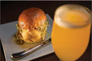  ?? Tribune News Servie ?? This fried cod sandwich is made with cod battered in Manifesto beer at Eagle Rock Public House in Los Angeles.