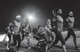  ?? ?? Basso, center, trains with his runners club, a group of friends and fans who run marathons to support awareness of progeria.