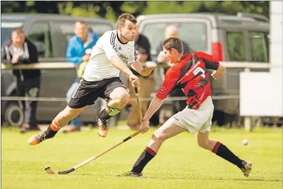  ?? Photograph by Neil Paterson. ?? Lovat’s Greg Matheson flies past Lochlan Smith of Glenurquha­rt.