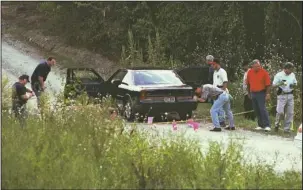  ?? The Sentinel-Record/File photo ?? COLD CASE: Garland County sheriff’s investigat­ors, Arkansas State Police and the Arkansas Medical Examiner’s collect evidence from the scene of a brutal double homicide on Aug. 31, 1997, on Hayti Lane, located just off Bald Mountain Road. The case...