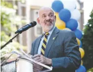  ?? STAFF PHOTO BY TIM BARBER ?? UT President Joe DiPietro speaks Thursday outside the Gary W. Rollins College of Business in Chattanoog­a during a campus-wide celebratio­n of the Rollins’ $40 million gift to the school. DiPietro announced his retirement Monday.
