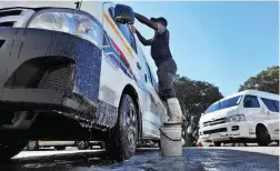  ?? PICTURE: DAVID RITCHIE/ANA PICTURES ?? SPLASHING OUT: The City of Cape Town says informal car washes use too much water. Pictured is a car wash/taxi holding area in Claremont.