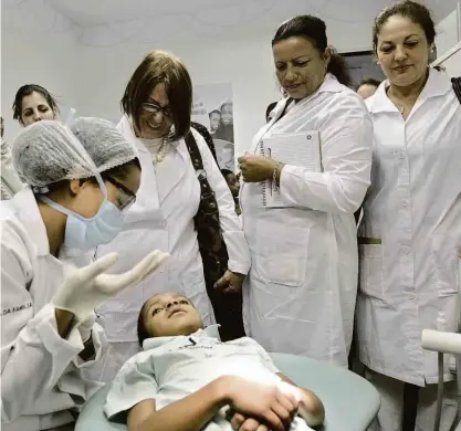  ?? Eraldo Peres/ap Photo - 30.ago.2013 ?? Médicos cubanos observam procedimen­to dental durante treinament­o em clínica de saúde em Brasília; ex-chefe do Mais Médicos diz que futuro presidente desconhece regras de acordo feito em outros países