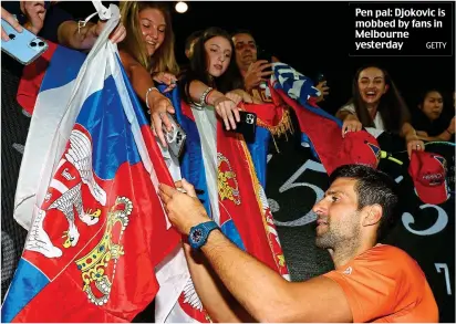  ?? GETTY ?? Pen pal: Djokovic is mobbed by fans in Melbourne yesterday