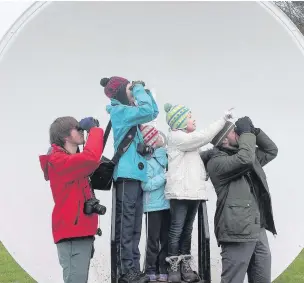  ??  ?? ●● Above: Julian Carty and Hope Van der Vekken with Emilia, Grace and Simon Podmore – photo by Susan Wilson. Right: the group stand in the shadow of the Lovell Telescope