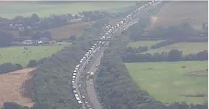  ??  ?? Tailbacks stretch for up to 12 miles as some people endure a 15-hour wait