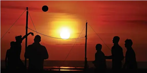  ?? Picture: Andrew Teebay ?? Playing beach volleyball as the sun sets at Ainsdale