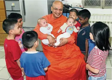  ?? — Filepic ?? Dhammarata­na with some of the kids at the Ti-Ratana home earlier this year. He wants to make sure the elderly are also well-cared for.