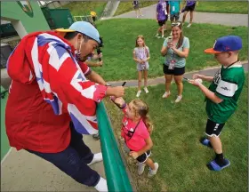  ?? (AP/Gene J. Puskar) ?? Los Angeles Angels catcher Kurt Suzuki signs autographs Sunday for fans at the Little League World Series in Williamspo­rt, Pa. Suzuki and the Angels were in town before they played the Cleveland Indians later that night.