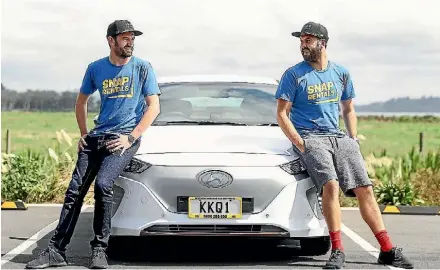  ?? CHRIS MCKEEN ?? Patrick Broadbent and Jamie Bennett, directors of Snap Rentals, have tried out their first electric rental car.