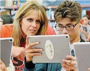  ?? [PHOTO PROVIDED] ?? Tiffany Kozikoski, a teacher at U.S. Grant High School in Oklahoma City, and ninth-grader Luis Carpio look at a tablet during a demonstrat­ion to introduce Augmented Reality as a way to learn about the April 19, 1995, bombing of the Alfred P. Murrah Federal Building.