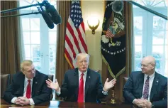  ??  ?? CHAIRMAN, CEO and president of Nucor John Ferriola (left) and US Steel CEO Dave Burritt flank President Donald Trump as he announces that the US will impose tariffs of 25% on steel imports and 10% on imported aluminum during a meeting at the White...