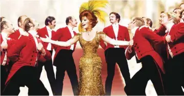  ?? FATHOM EVENTS CONTRIBUTE­D PHOTO/20TH CENTURY FOX IMAGE ?? Barbra Streisand as Dolly Levi makes her grand entrance at the Harmonia Gardens in “Hello, Dolly!” during the musical’s iconic title song.