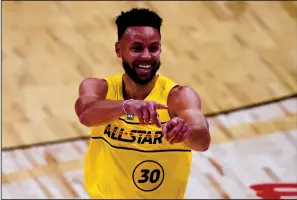  ?? TRIBUNE NEWS SERVICE ?? Golden State Warriors guard Stephen Curry celebrates after scoring during the first half of Sunday's NBA All-Star Game in Atlanta.